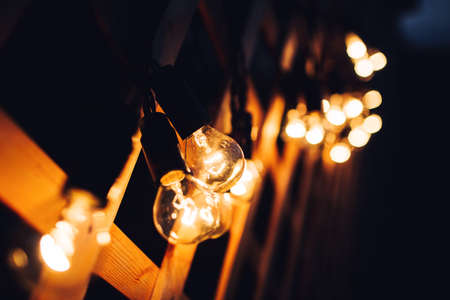 glowing bulb uniqueness concept on brown wooden tableの写真素材
