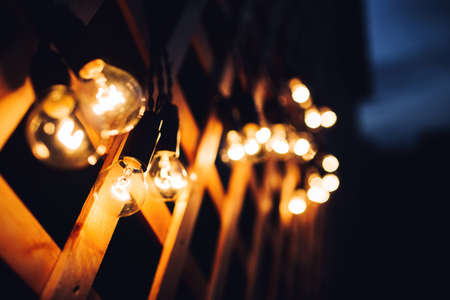 glowing bulb uniqueness concept on brown wooden tableの写真素材