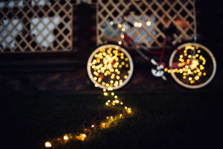 Christmas lights on bike background texture in cityの写真素材