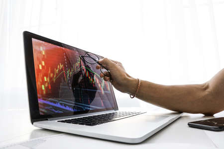 businessman shows the screen on laptop the graph of growthの写真素材