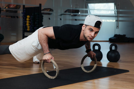 man in sportswear is training in the gym