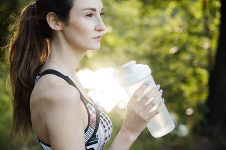 the girl is engaged in fitness and meditates in the park city