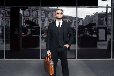 businessman with a bag near the office talking on the phoneの写真素材
