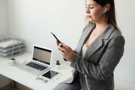 younger girl working in the office at the tableの写真素材