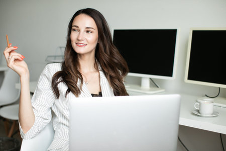 girl in the office holding a laptop
