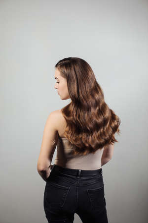 Closeup of female hands of hairdresser or coiffeur makes hairstyle. Hairの写真素材
