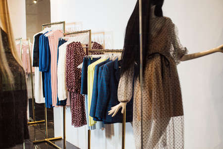 Close-up view of various stylish clothes hanging on hangers in boutique. Clothesの写真素材