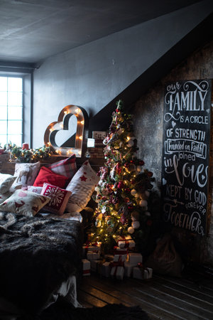 Christmas tree in a beautifully decorated house with Christmas gifts under itの写真素材