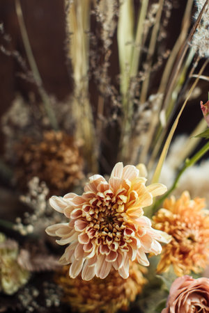 Beautiful autumn bouquet of mixed flowers with dry branches. The work of the florist. Beautiful bouquet. Flower deliveryの写真素材