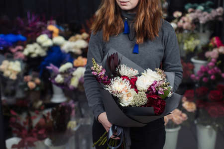 Beautiful bouquet of mixed flowers with peonies. The work of the florist. Flower deliveryの写真素材