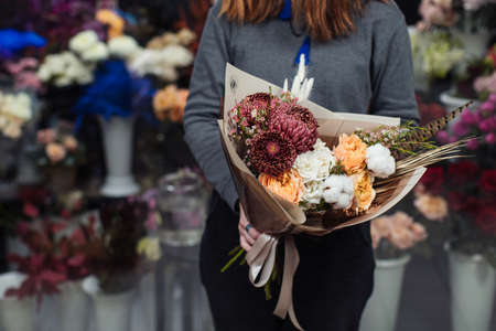 Beautiful bouquet of mixed flowers with peonies. The work of the florist. Flower deliveryの写真素材