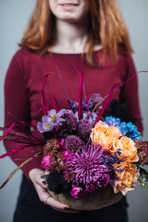 Beautiful bouquet of mixed flowers with peonies. The work of the florist. Flower deliveryの写真素材
