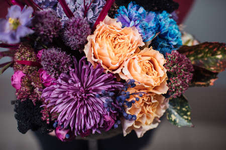Beautiful bouquet of mixed flowers with peonies. The work of the florist. Flower deliveryの写真素材