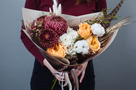 Beautiful bouquet of mixed flowers with peonies. The work of the florist. Flower deliveryの写真素材