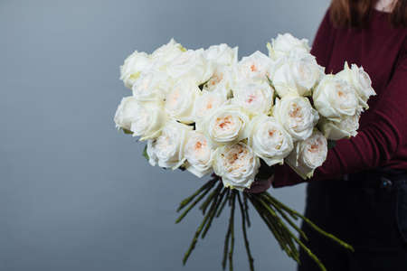 Close-up of white roses. A girl holding a rose. Flowersの写真素材