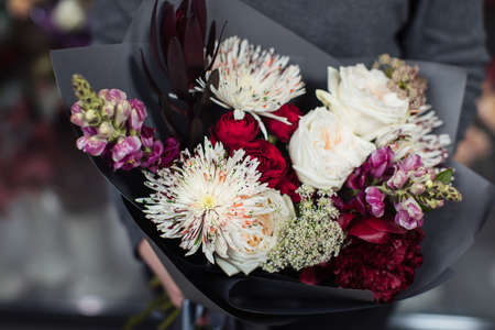 Beautiful bouquet of mixed flowers with peonies. The work of the florist. Flower deliveryの写真素材