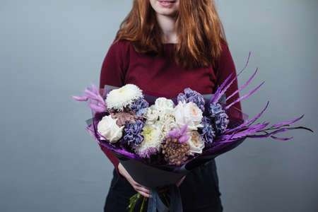 Beautiful bouquet of mixed flowers with peonies. The work of the florist. Flower deliveryの写真素材
