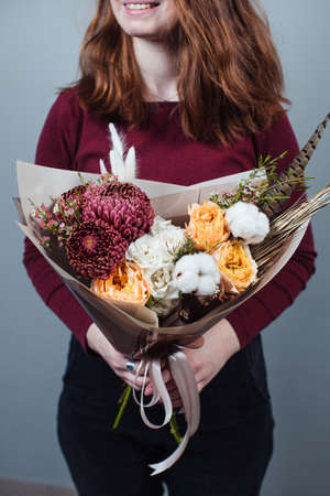 Beautiful bouquet of mixed flowers with peonies. The work of the florist. Flower deliveryの写真素材