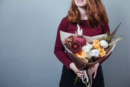 Beautiful bouquet of mixed flowers with peonies. The work of the florist. Flower deliveryの写真素材