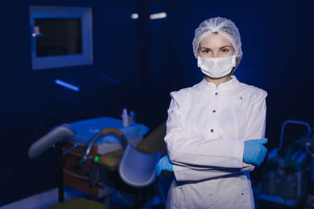 Portrait of Young Female Doctor in Medical Mask Looking at Cameraの写真素材