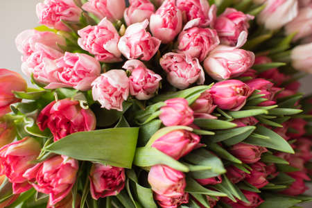 Close-up Large Beautiful bouquet of mixed tulips. Flower background and Wallpaper. Floral shop concept . Beautiful fresh cut bouquet. Flowers deliveryの写真素材
