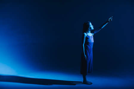Young stylish girl dancing in the Studio on a colored neon background. Classic dancer.の写真素材