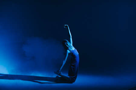 Young stylish girl dancing in the Studio on a colored neon background. Classic dancer.の写真素材