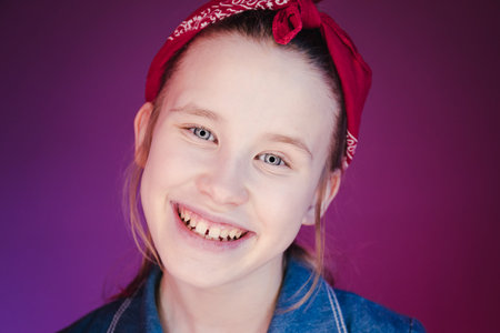Young stylish girl in the Studio on a colored neon background. Music dj poster design. Portrait of a young girl dancer.の写真素材