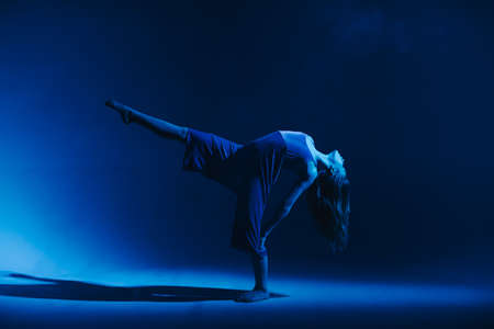 Young stylish girl dancing in the Studio on a colored neon background. Classic dancer.の写真素材