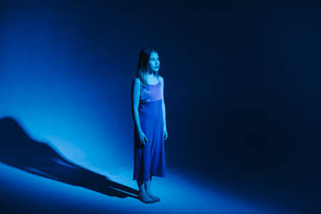 Young stylish girl dancing in the Studio on a colored neon background. Classic dancer.の写真素材