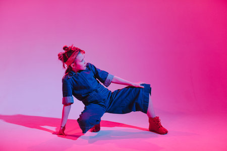 Young stylish girl dancing in the Studio on a colored neon background. Music dj poster design.