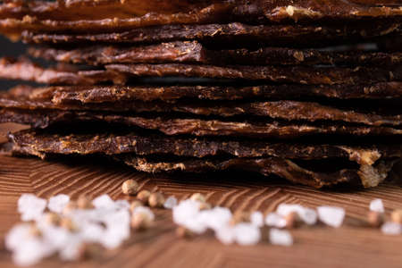 Close-up of a piece of meat on a wooden Board with spices. Restaurant menu, a series of photos of different dishesの写真素材