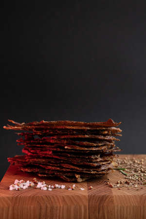 Close-up of a piece of meat on a wooden Board with spices. Restaurant menu, a series of photos of different dishesの写真素材