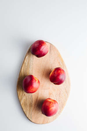 Close-up of ripe peaches on the table. Ripe peaches with leavesの写真素材