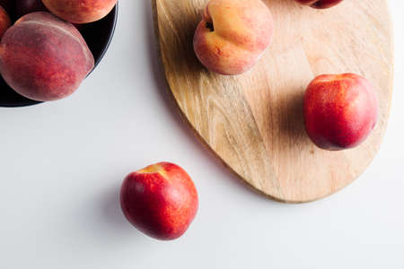Close-up of ripe peaches on the table. Ripe peaches with leavesの写真素材