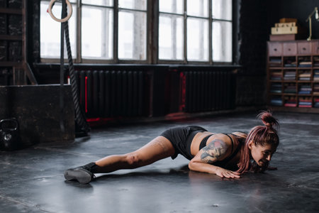 Young girl doing sports in the gym. Atmospheric gymの写真素材