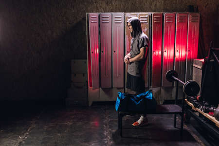 Man get ready for boxing training in the locker roomの写真素材