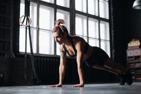 Young girl doing sports in the gym. Atmospheric gym