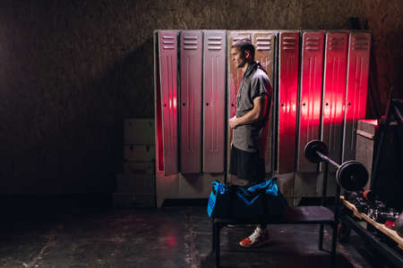 Man get ready for boxing training in the locker roomの写真素材