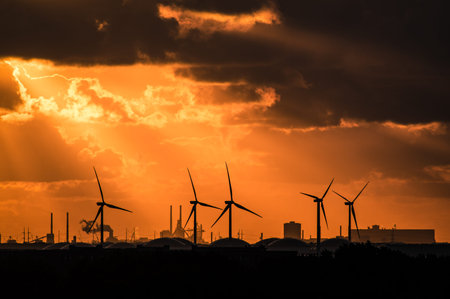 Sunset silhouetting electric windmills in Amsterdam, the Netherlandsの写真素材