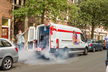 A man with a saxophone outside his party van on the street in The Hagueのeditorial素材