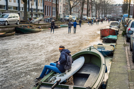 People ice skating on the frozen city canals in Amsterdam, Winter 2018の写真素材