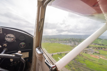 The view from the right side seat of a small single-engine plane, looking out over the Sacramento...