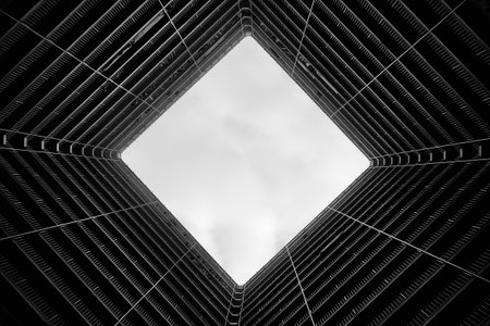 Looking up into the sky through a modern residential buildingのeditorial素材