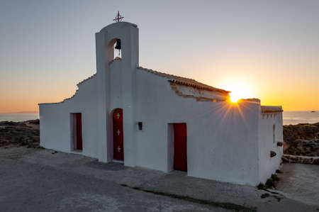Zakynthos Island, Greece. A pearl of the Mediterranean with beaches and coasts suitable for unforgettable sea holidays. church on the sea in Agios Nikolaos Beach at sunrise.の写真素材