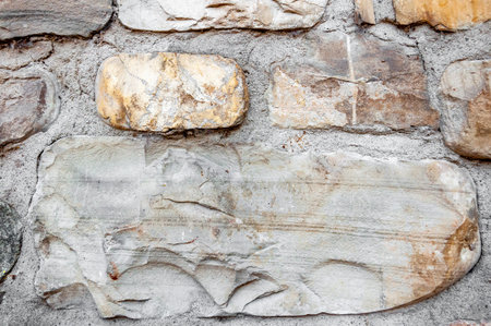 Typical wall of ancient Italian house made of hand-carved stones and bricks