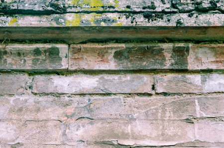 Typical wall of ancient Italian house made of hand-carved stones and bricksの写真素材