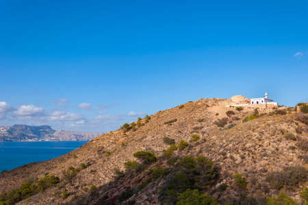 The Albir lighthouse in Altea, a town on the Mediterranean coast of the Costa Blanca, a tourist destination in Spain. Near Benidorm, the town of Altea and nearby Albir enjoy a fantastic sea climate all year round.の写真素材