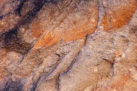 Detail of typical wall stone of an ancient Italian house, carved from hand-made rock, eroded and consumed by time.の写真素材