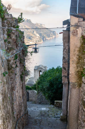 Ravello, a splendid village and tourist resort on the famous Amalfi Coast. View of the pedestrian street that descends to the sea and to Amalfi, with detail of the church of "Santa Maria delle Grazie".の写真素材
